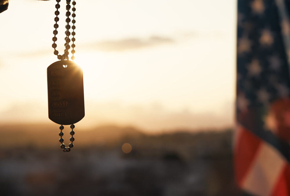 Dog tag and american flag at sunset to represent veteran counseling for anger management, PTSD, alcoholism and more