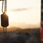 Dog tag and american flag at sunset to represent veteran counseling for anger management, PTSD, alcoholism and more