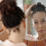 Woman looking in mirror - When Self-Doubt Gets Loud: Support for Low Self-Esteem and Body Image