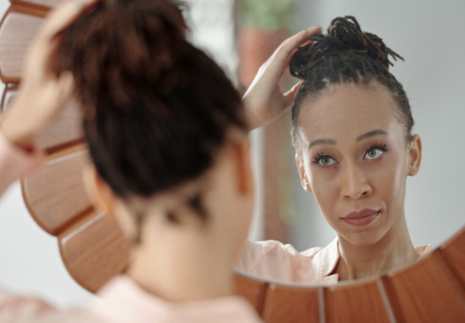 Woman looking in mirror - When Self-Doubt Gets Loud: Support for Low Self-Esteem and Body Image